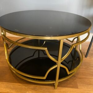 Two tiered gold metal coffee table with black glass. 18”H, 31”D