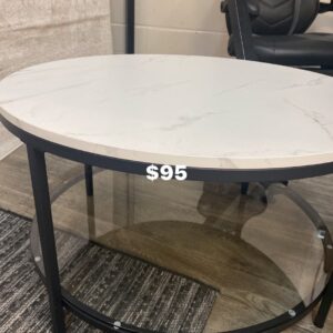 Marble look coffee table with glass bottom shelf on black metal frame. 31.5”D, 18”H
